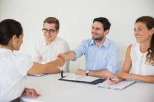 Recruit shaking hands with team