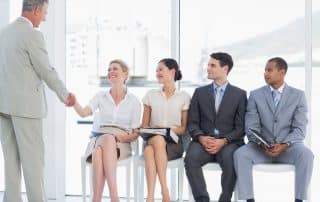 Businessman shaking hands with woman by people waiting for interview, CBR, PEO, HR, Payroll