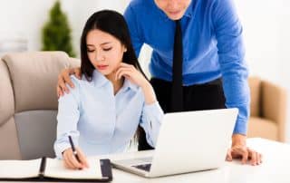 Business man harassing female colleague in office, HR Outsourcing