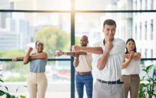 workout, stretching and a group of business people in the office to exercise for health or mobility together. fitness, wellness and coach training an employee team in the workplace for a warm up